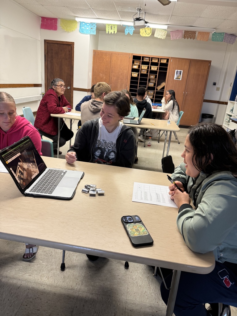 A group of native speakers from the community were invited in to describe a house they wanted built, and then Mrs. Hughes' Spanish students created and presented a design and argued why it was better than their classmates' designs. 