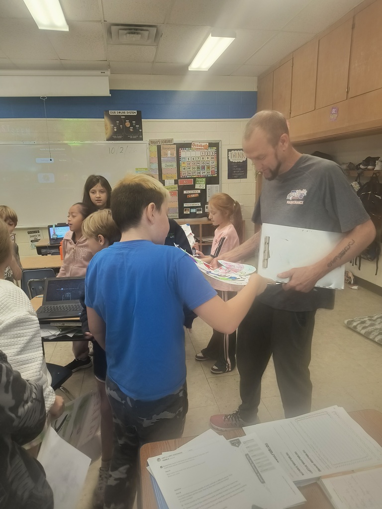 On National Custodians Day, Mrs. Simnitt's 4th graders created personalized posters and presented them to Mr. Langley and Mr. Dunlap.