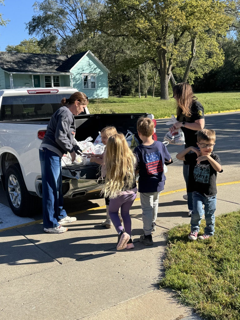 Mrs. Shannon’s kindergarten students sack and load all of the canned vegetables collected from their recent food drive.