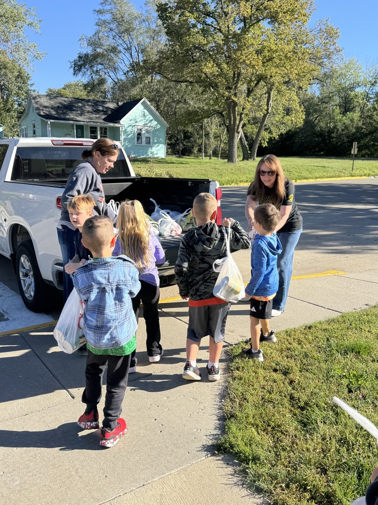 Mrs. Shannon’s kindergarten students sack and load all of the canned vegetables collected from their recent food drive.