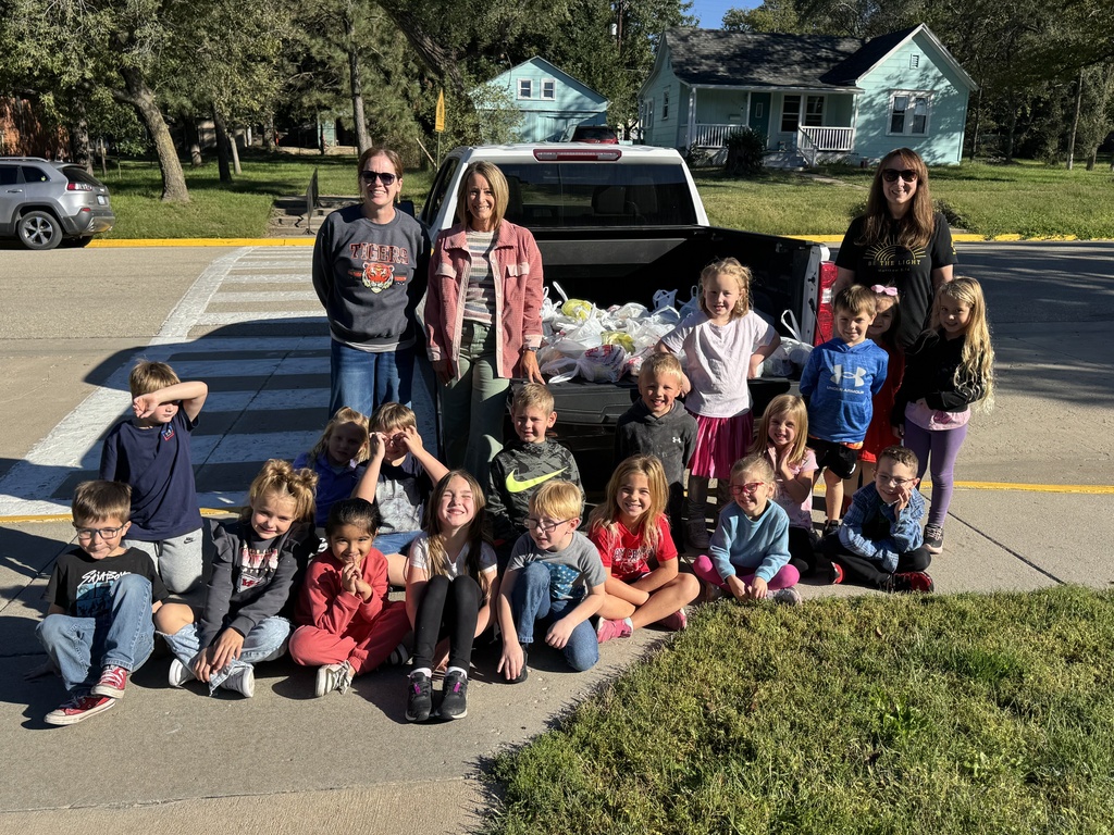 Mrs. Shannon’s kindergarten students sack and load all of the canned vegetables collected from their recent food drive.