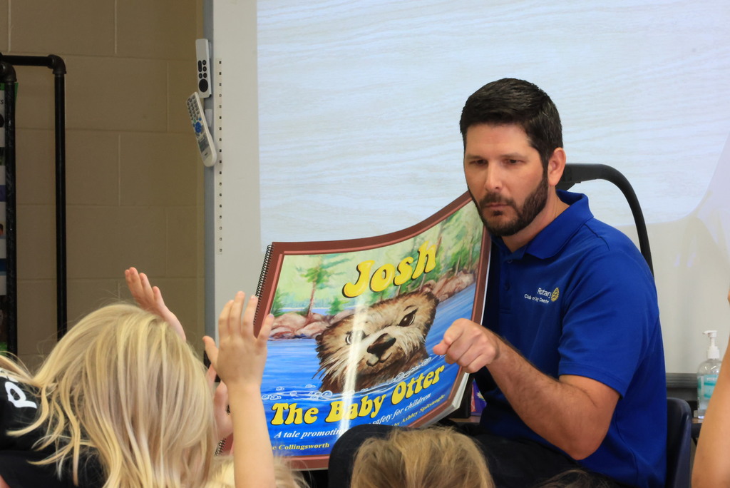 Clay Center Rotary members read "Josh, the Baby Otter" while promoting water safety.