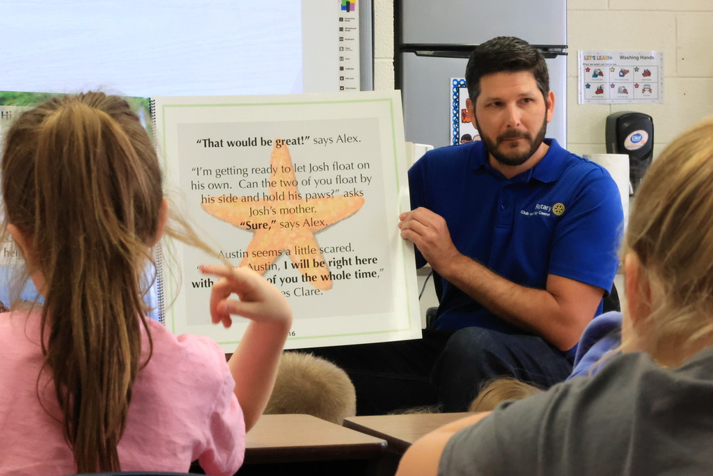 Clay Center Rotary members read "Josh, the Baby Otter" while promoting water safety.