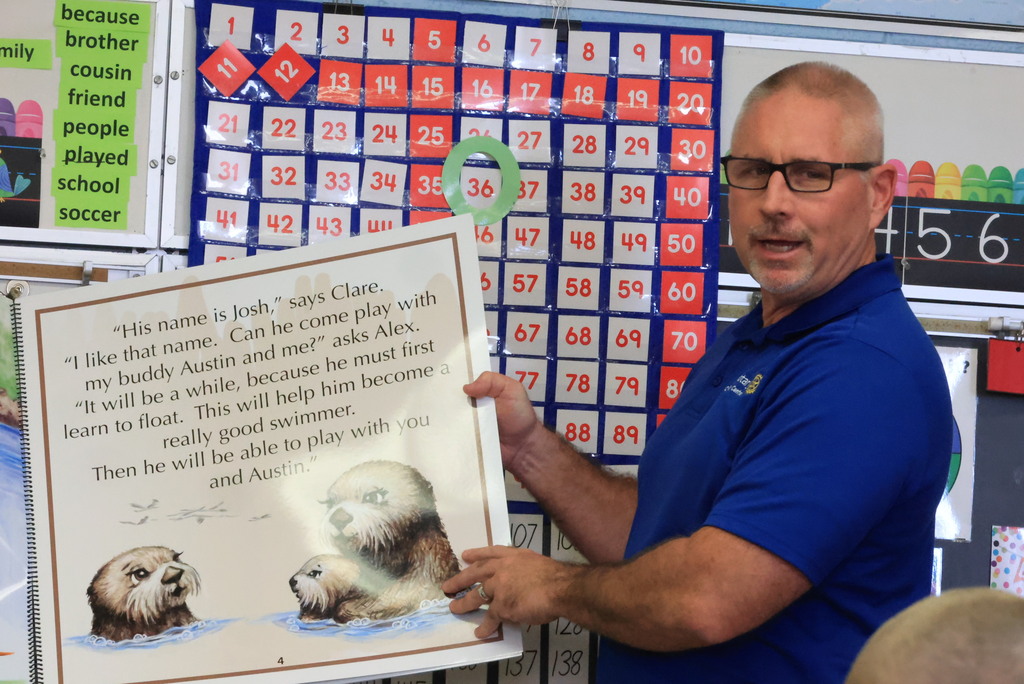 Clay Center Rotary members read "Josh, the Baby Otter" while promoting water safety.
