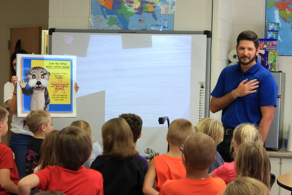 Clay Center Rotary members read "Josh, the Baby Otter" while promoting water safety.