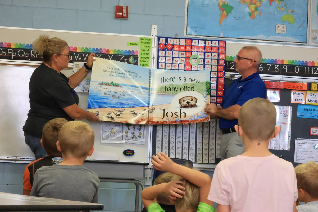 Clay Center Rotary members read "Josh, the Baby Otter" while promoting water safety.