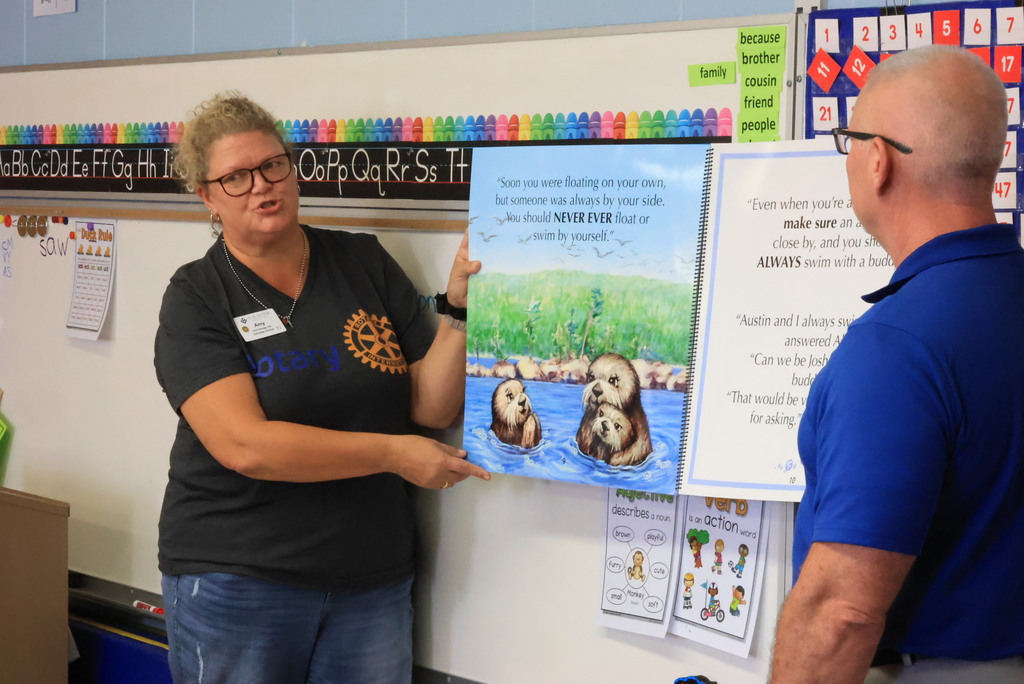 Clay Center Rotary members read "Josh, the Baby Otter" while promoting water safety.