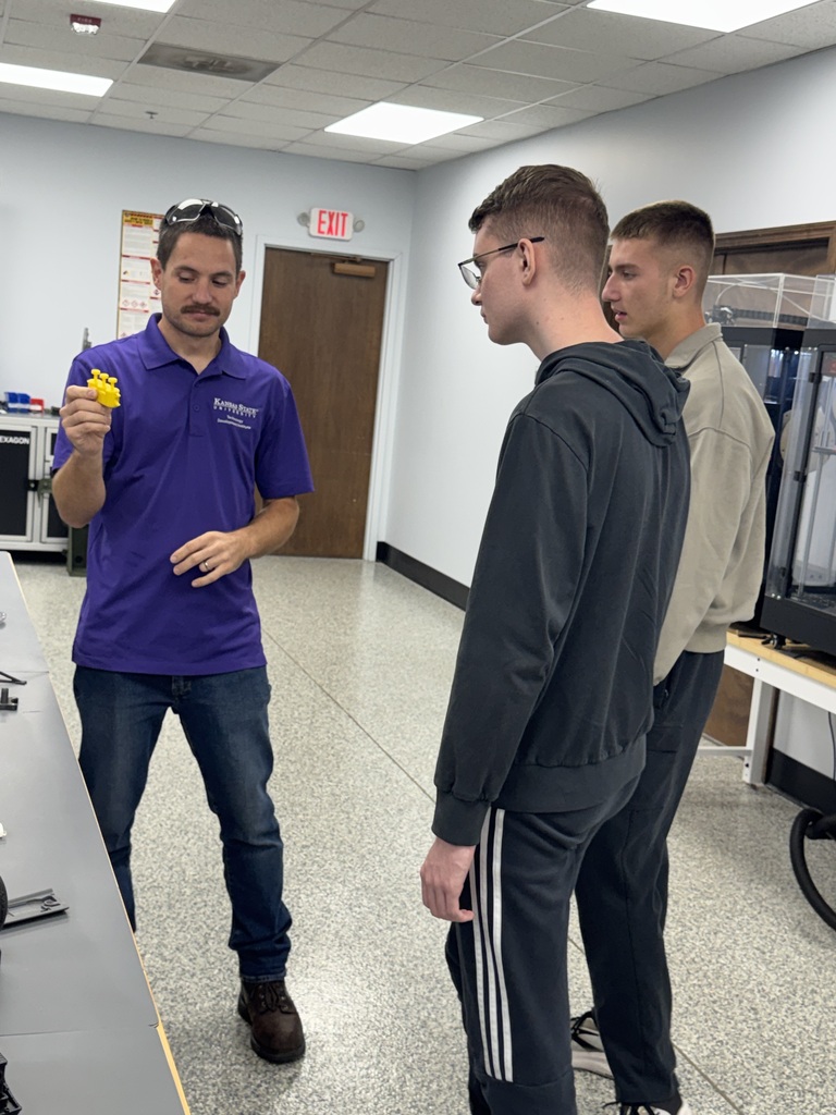 Executive Director Jeff Tucker and lead engineer Quinton Berggren explain the KSU Technology Development Institute's objectives to WHS students Max and Tim Bybee during a visit this week.