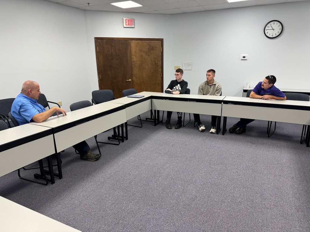 Executive Director Jeff Tucker and lead engineer Quinton Berggren explain the KSU Technology Development Institute's objectives to WHS students Max and Tim Bybee during a visit this week.