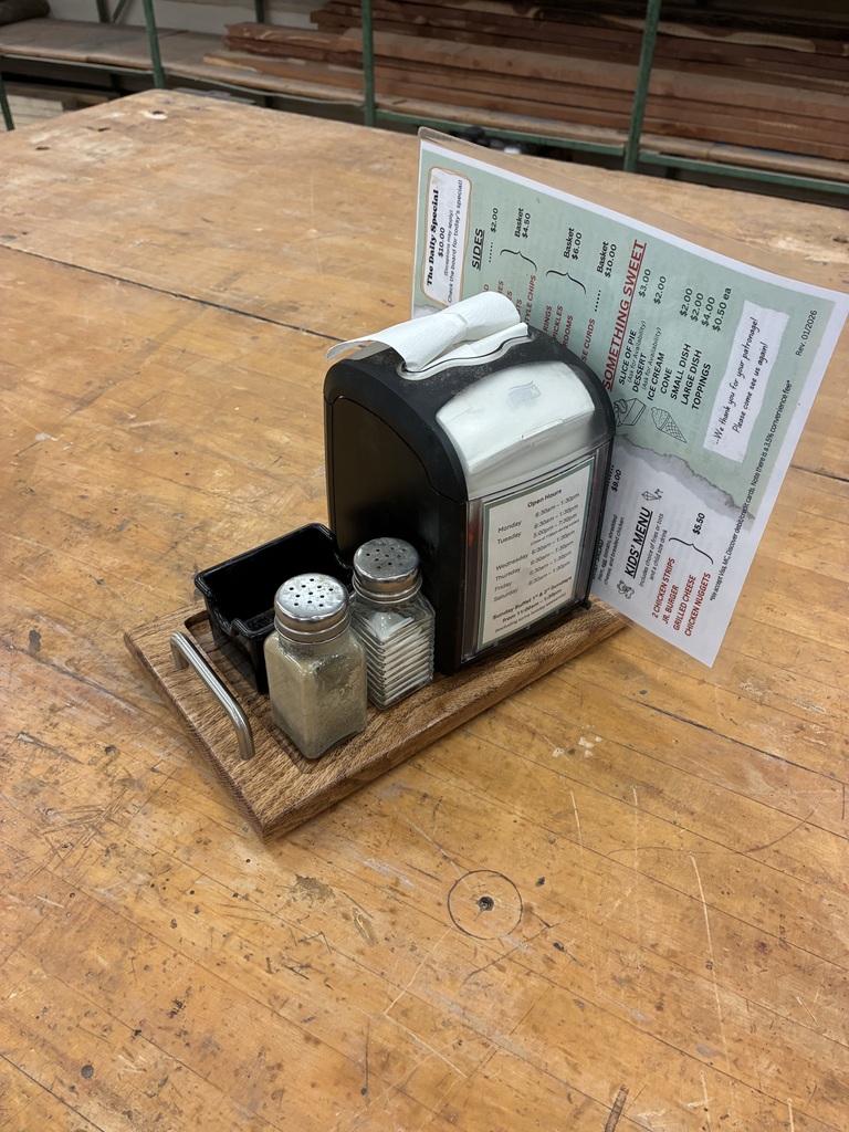 Back in August, Mrs. Schooley's Cabinetmaking students worked with the Green Community Cafe to create a holder for napkins, menus, salt and pepper shakers, and sugar containers. Today, they gave Mr. Lloyd the final product! 