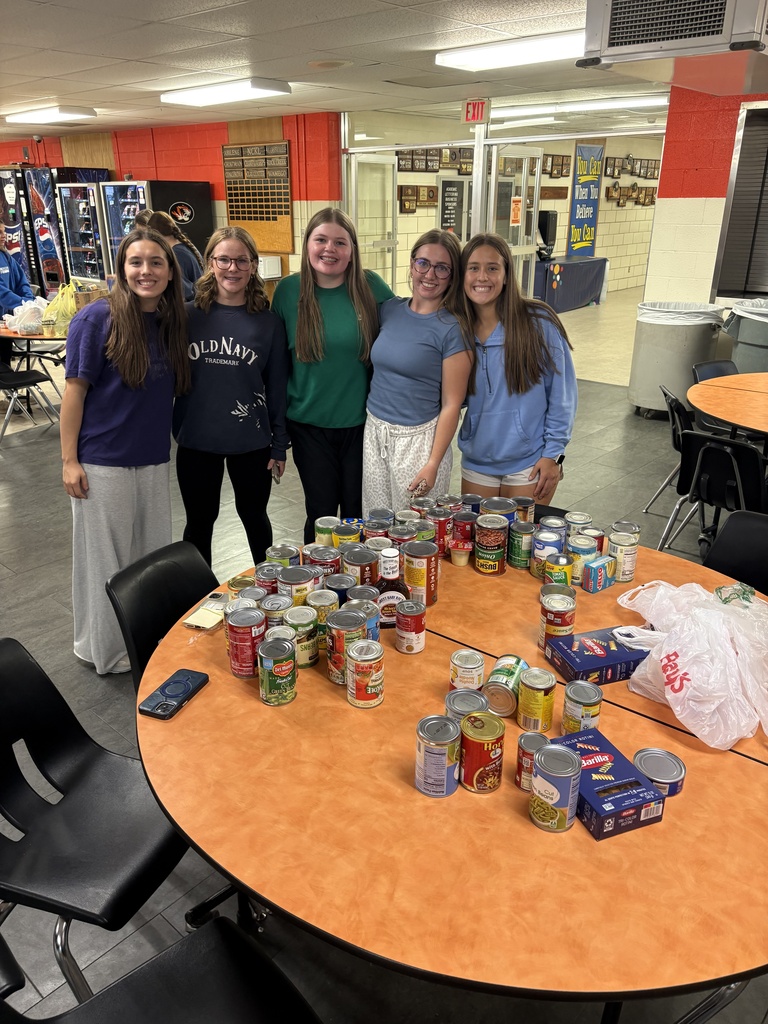 CCCHS FBLA members pose with their trick-or-treat for canned goods itmes.