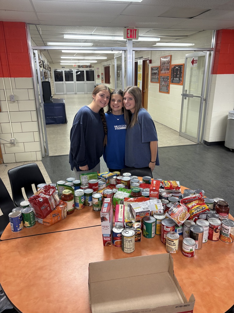CCCHS FBLA members pose with their trick-or-treat for canned goods itmes.