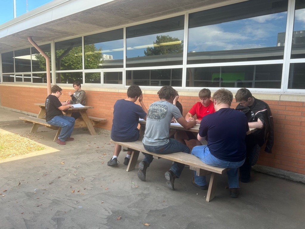 Mrs. Artman's Drawing/Painting class sits outside in the CCCHS commons while continuing to learn to draw contour lines. 