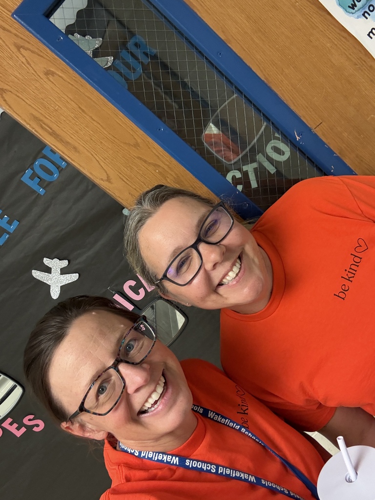 USD 379 staff members pose with their orange Unity Day Shirts to support Bullying Prevention Month.