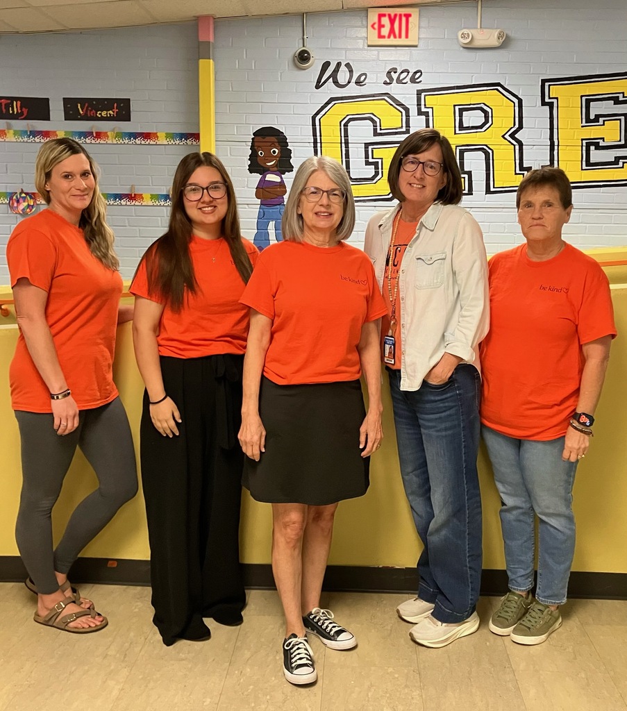 USD 379 staff members pose with their orange Unity Day Shirts to support Bullying Prevention Month.