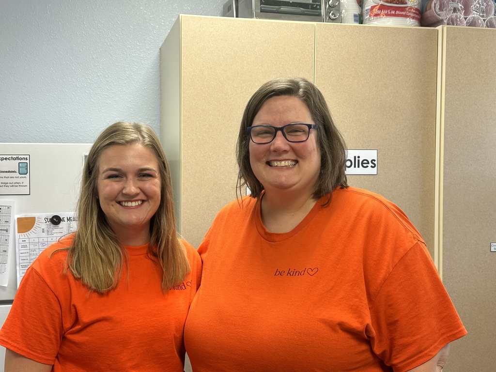 USD 379 staff members pose with their orange Unity Day Shirts to support Bullying Prevention Month.