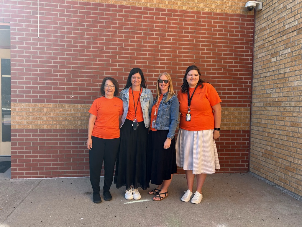 USD 379 staff members pose with their orange Unity Day Shirts to support Bullying Prevention Month.