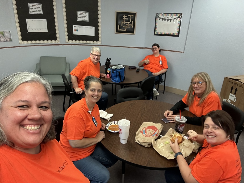 USD 379 staff members pose with their orange Unity Day Shirts to support Bullying Prevention Month.