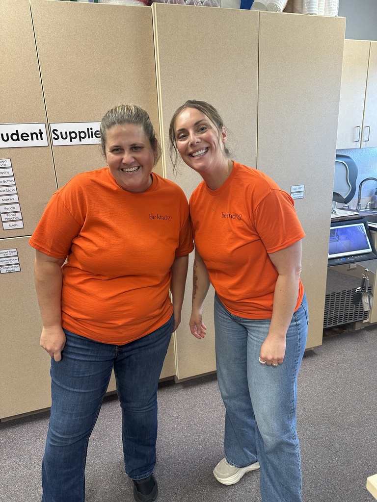 USD 379 staff members pose with their orange Unity Day Shirts to support Bullying Prevention Month.