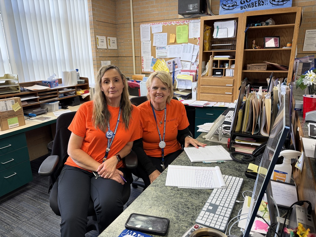USD 379 staff members pose with their orange Unity Day Shirts to support Bullying Prevention Month.