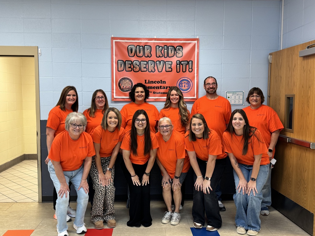 USD 379 staff members pose with their orange Unity Day Shirts to support Bullying Prevention Month.