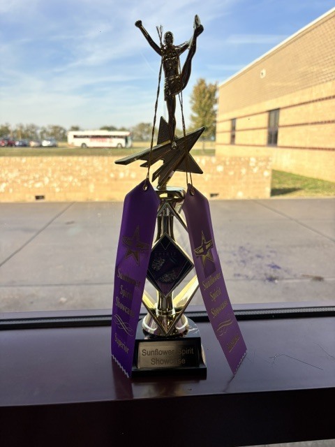 The trophy they earned at the competition is shown.
