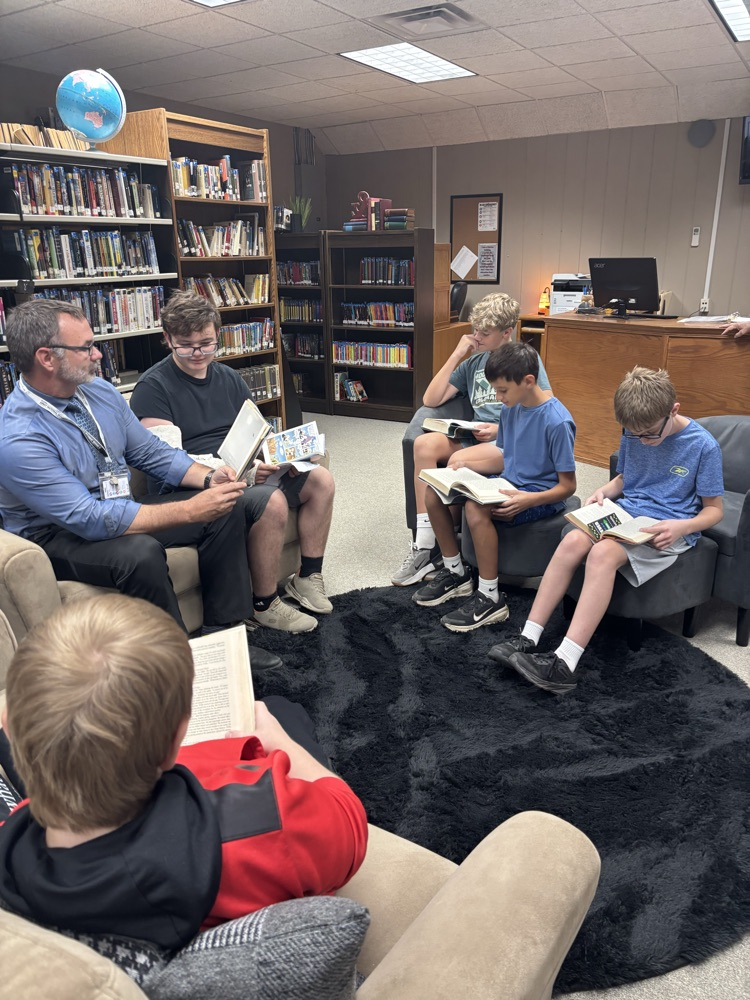 PHOTO OF MR. LOWE AND MIDDLE SCHOOL BOYS
