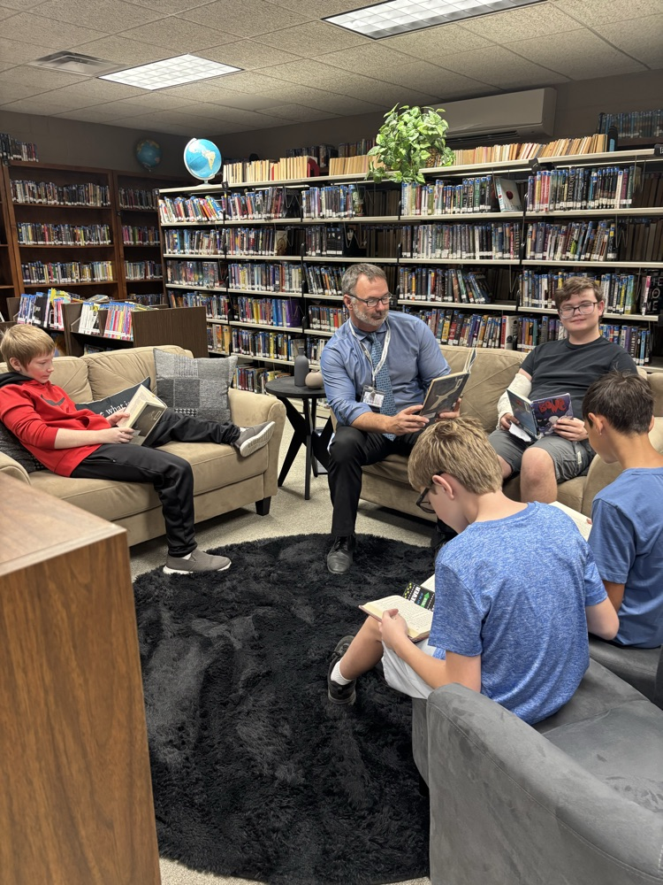 PHOTO OF MR LOWE AND MIDDLE SCHOOL BOYS