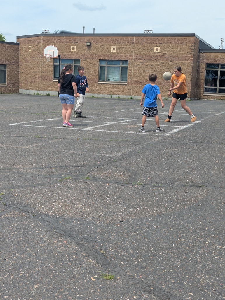 Students playing four square