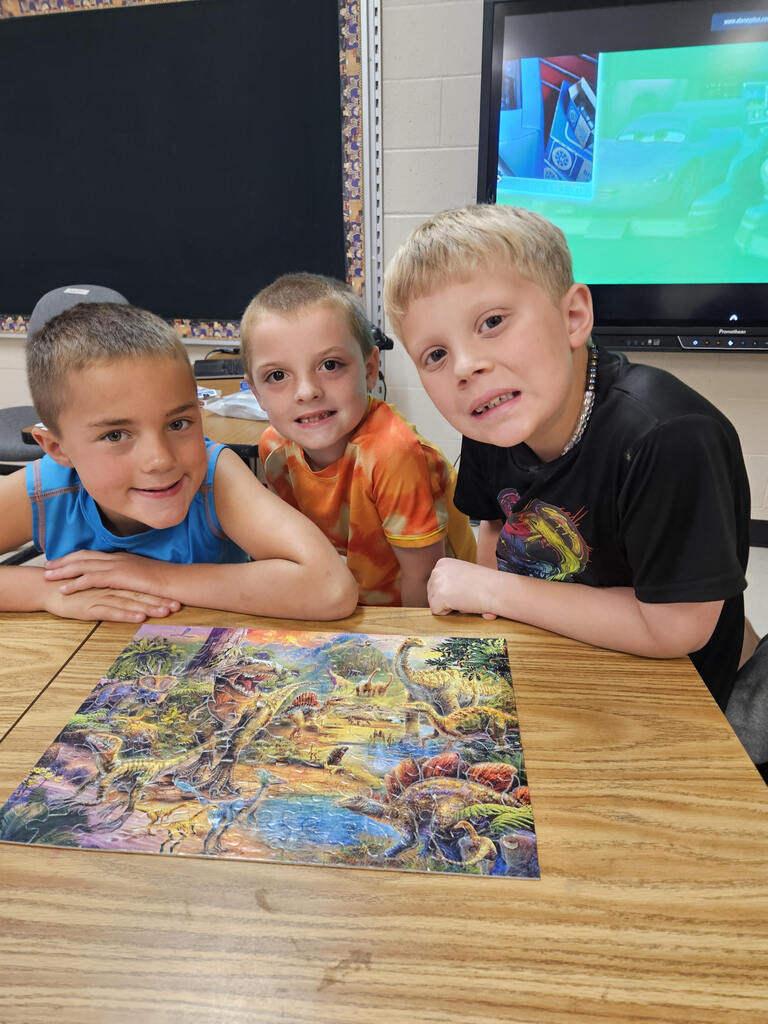 3 students with finished puzzle