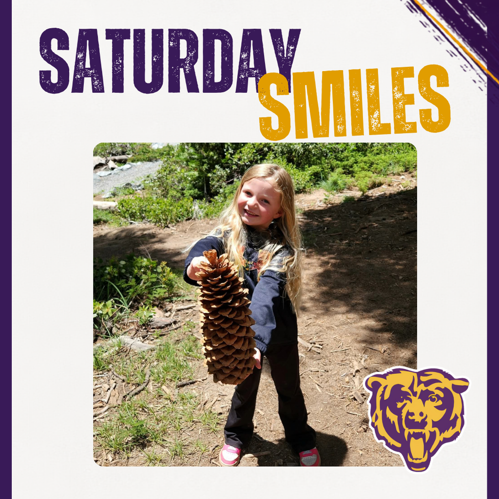 Saturday Smiles photo of student holding a giant pinecone.