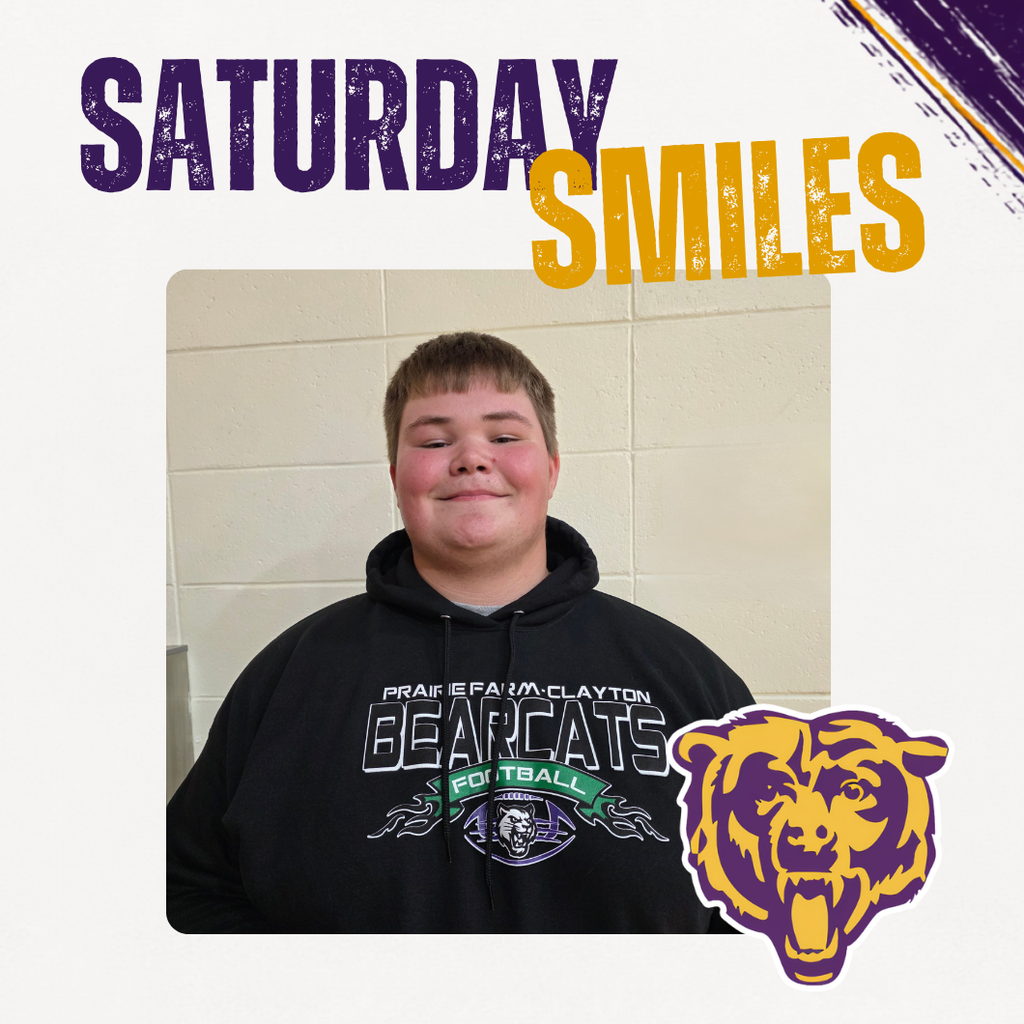 Saturday Smiles Post with a student smiling in front of a brick wall.