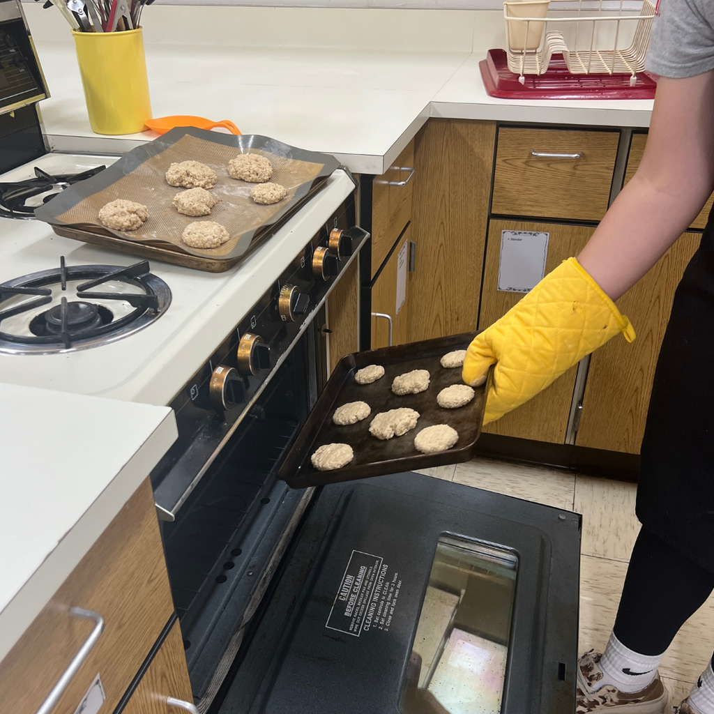 Cookies going in to the oven on a baking tray.