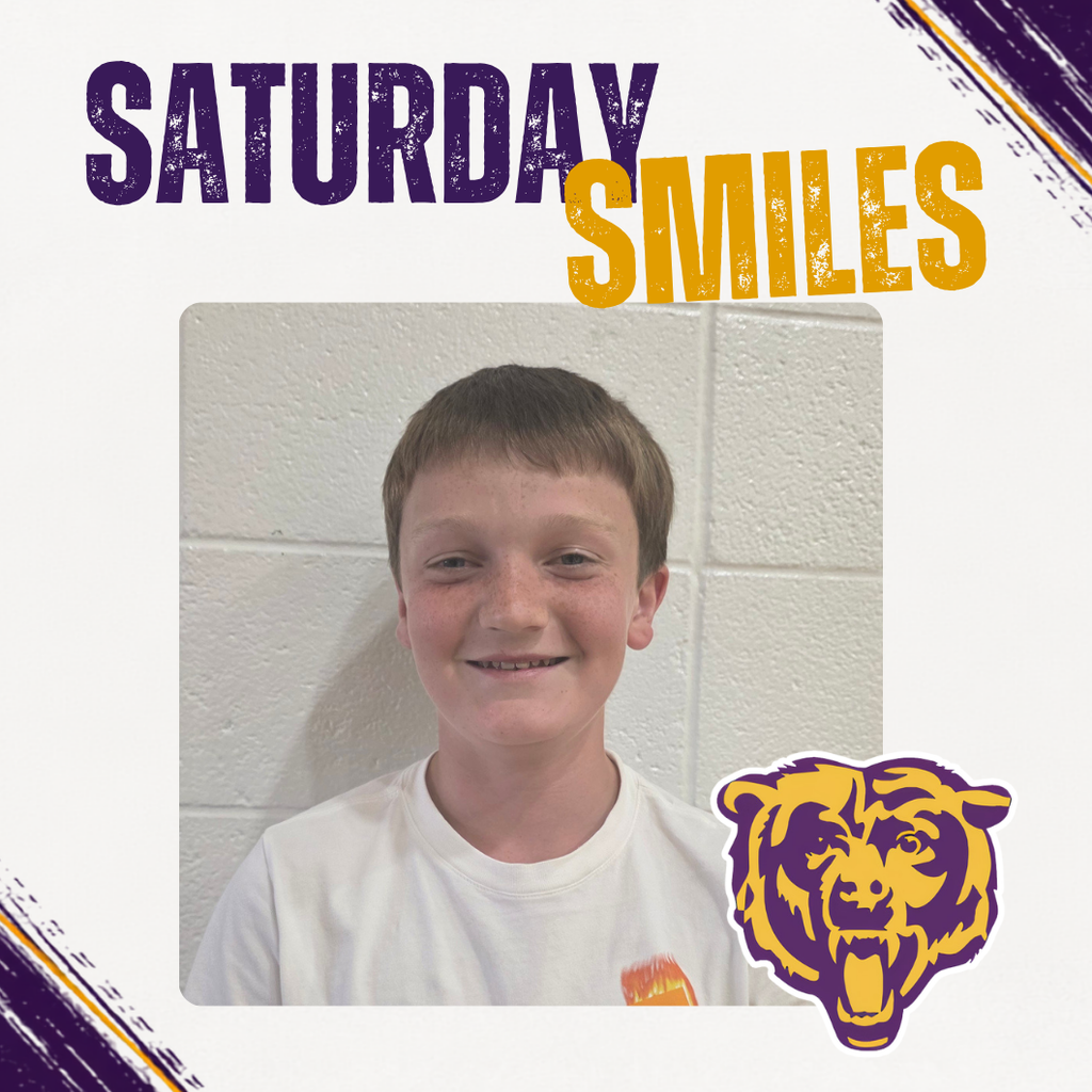 Saturday Smiles Post with a student smiling in front of a brick wall.
