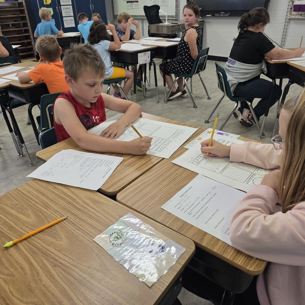 Students in the classroom learning about creatures