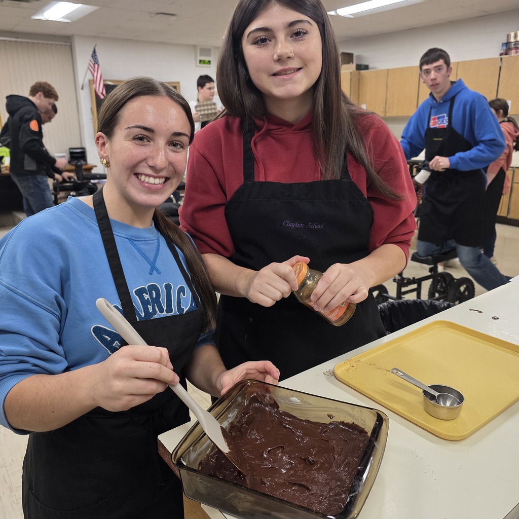 Student cooking brownies in a classroom.