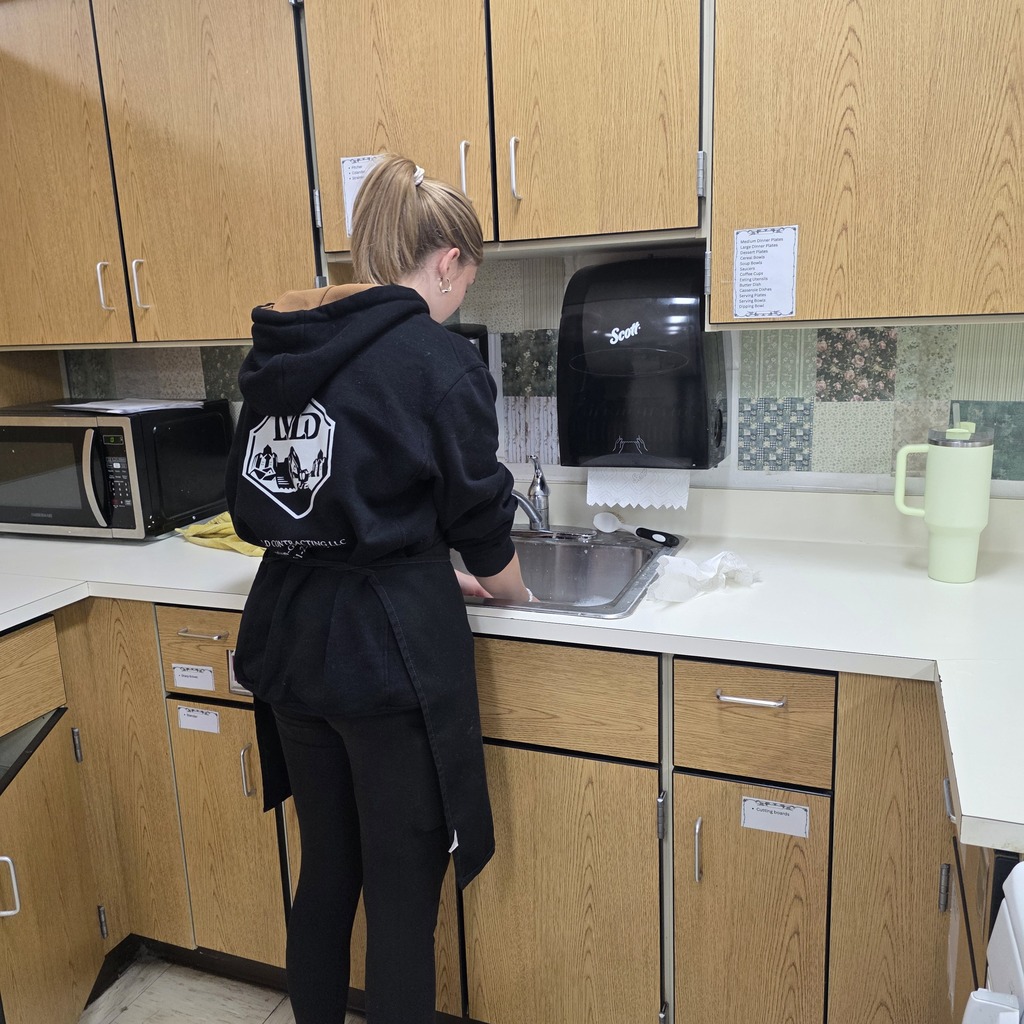 Student cooking brownies in a classroom.