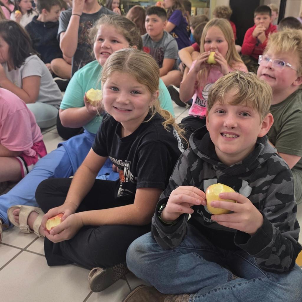 The great apple Crunch with student in a lobby eating apples.
