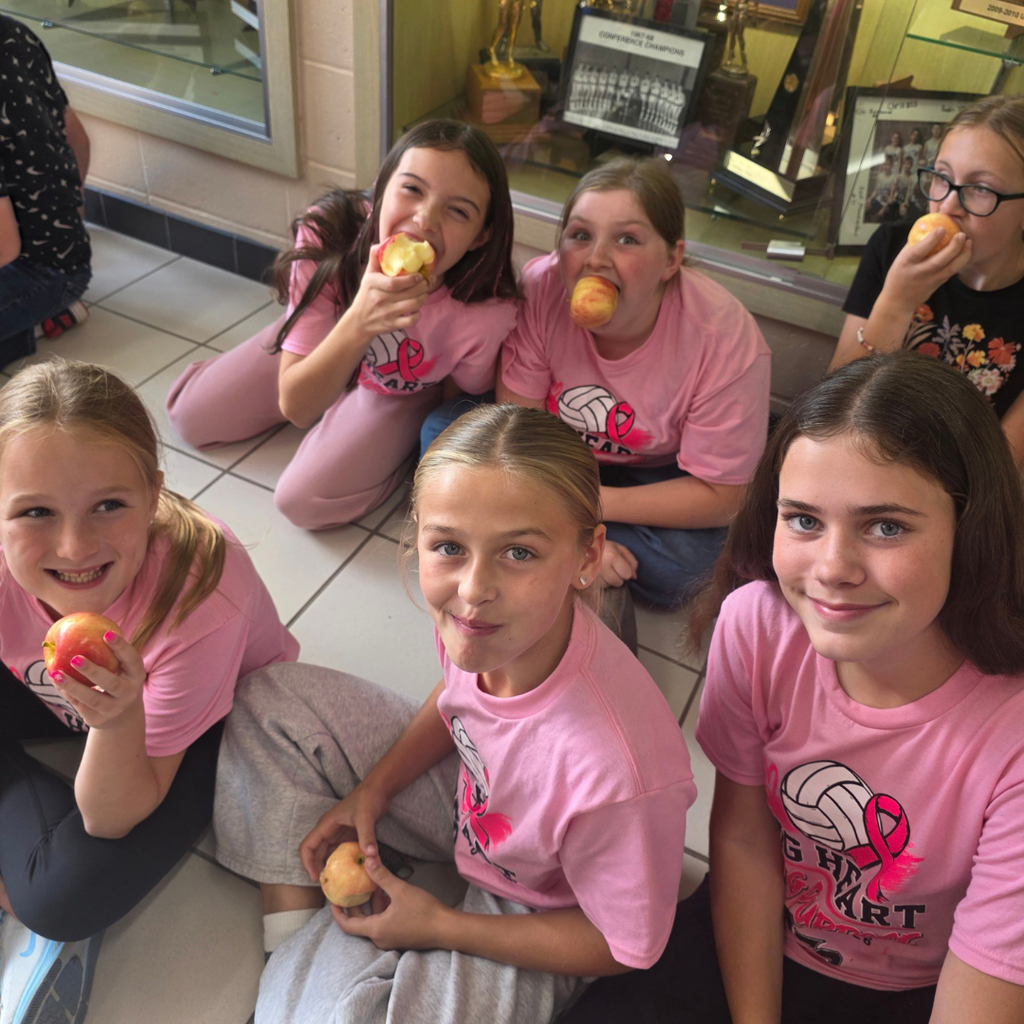 The great apple Crunch with student in a lobby eating apples.