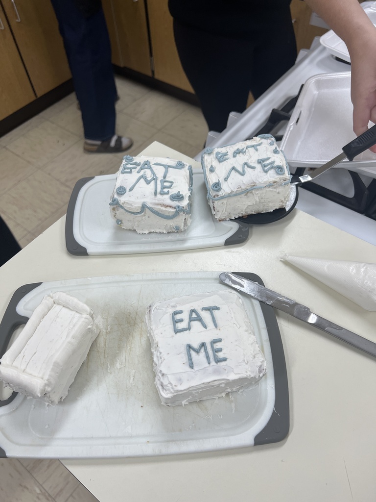 Photos of students with their cakes they made in Foods Class.