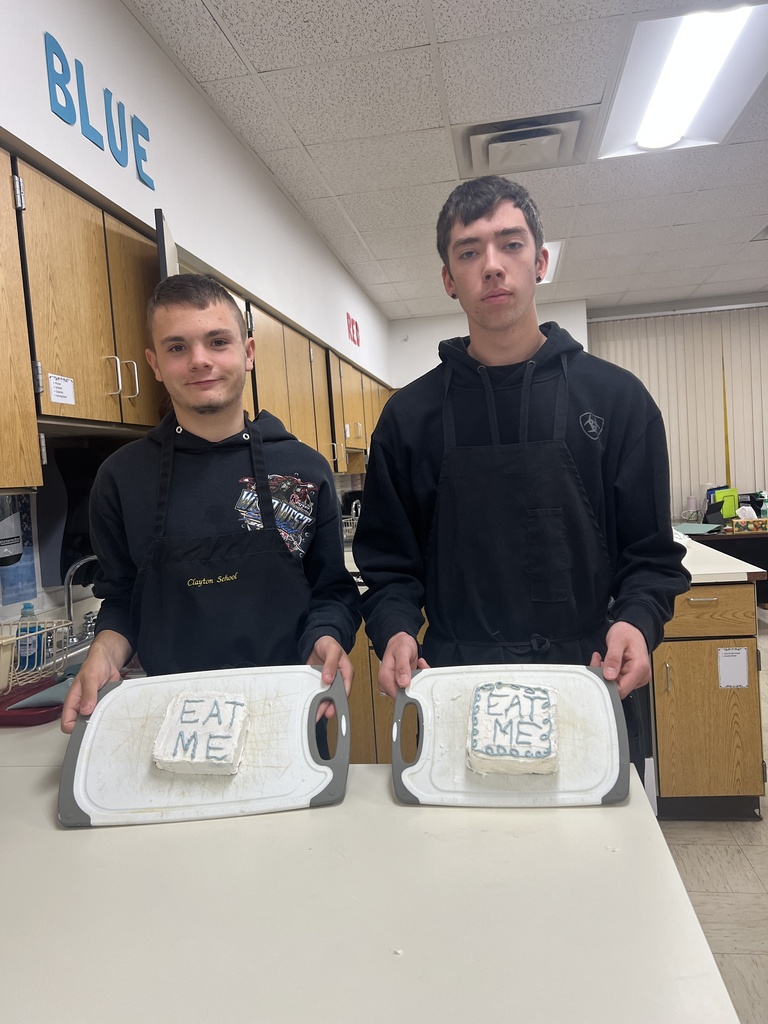 Photos of students with their cakes they made in Foods Class.