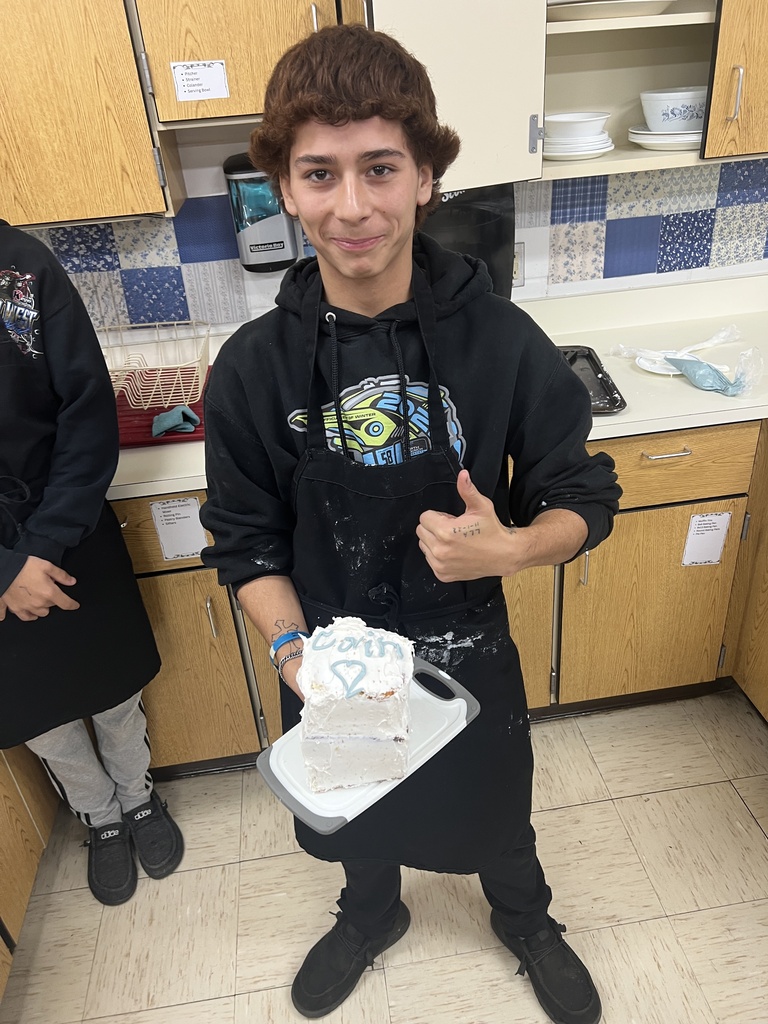 Photos of students with their cakes they made in Foods Class.