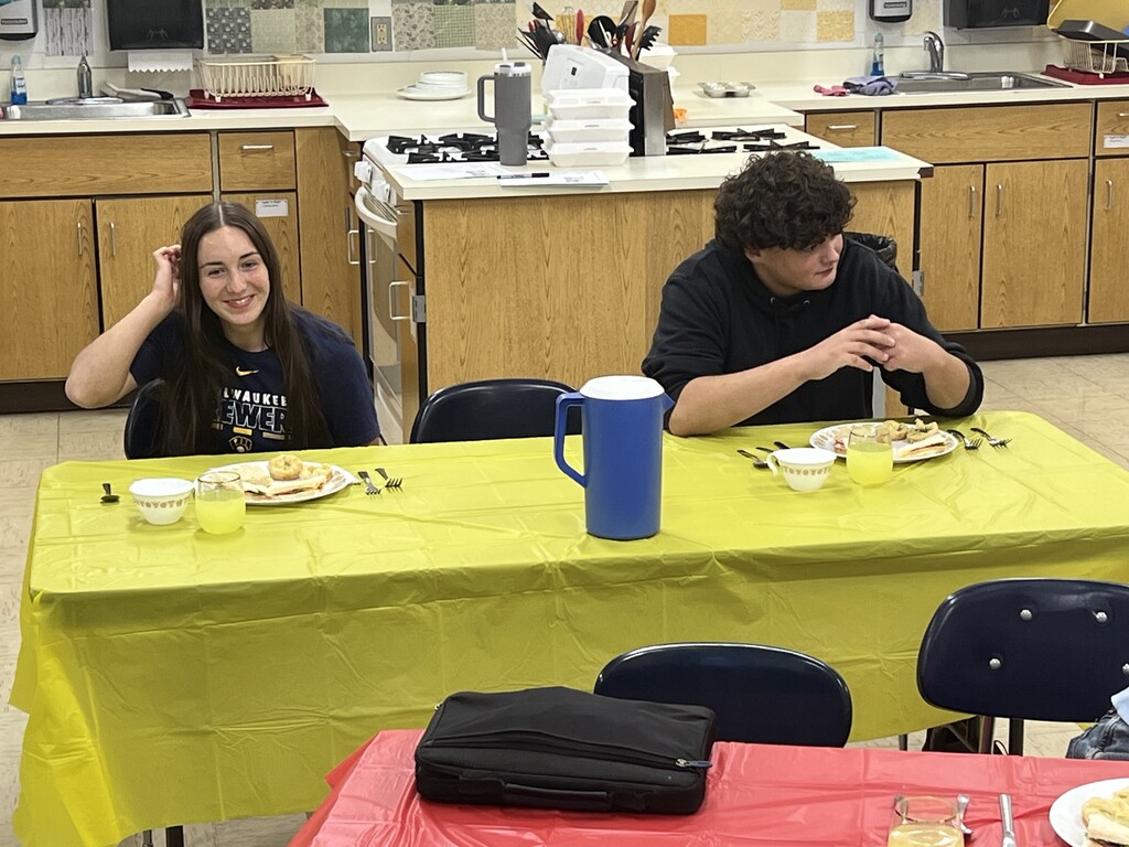 Students learning about table manners