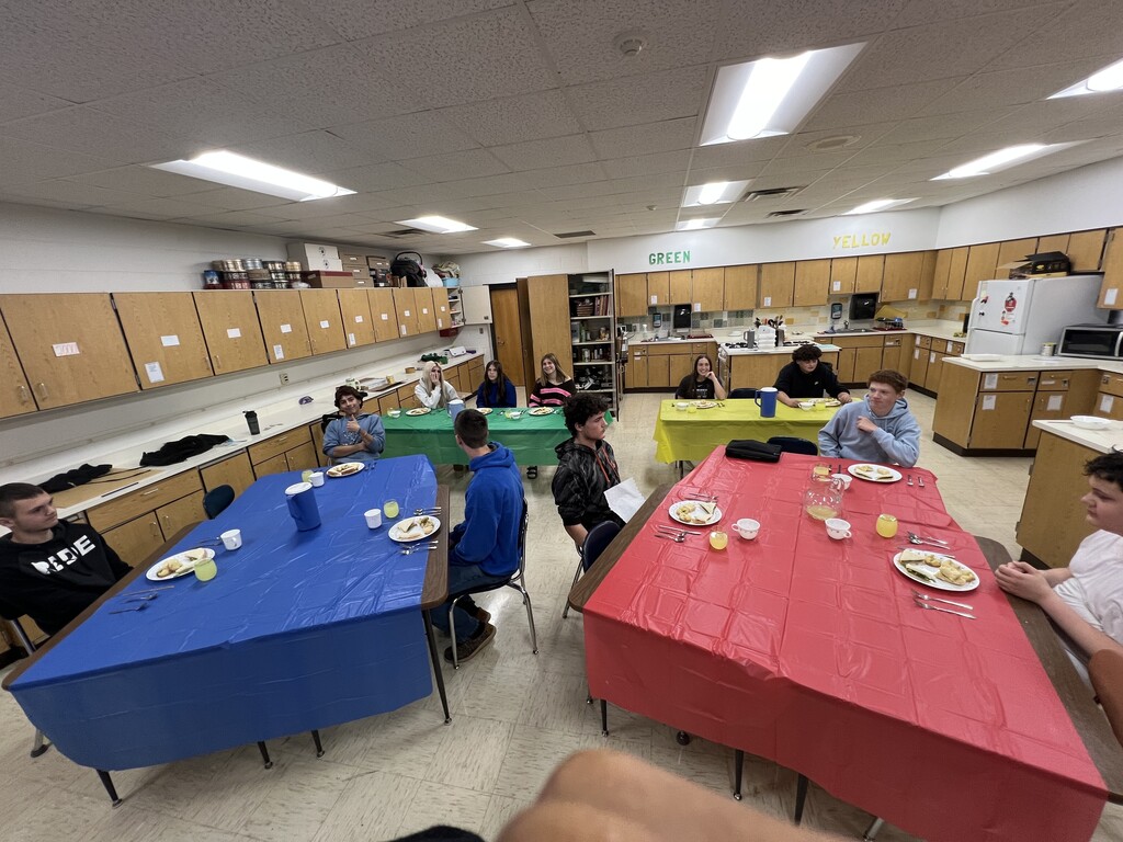 Students learning about table manners
