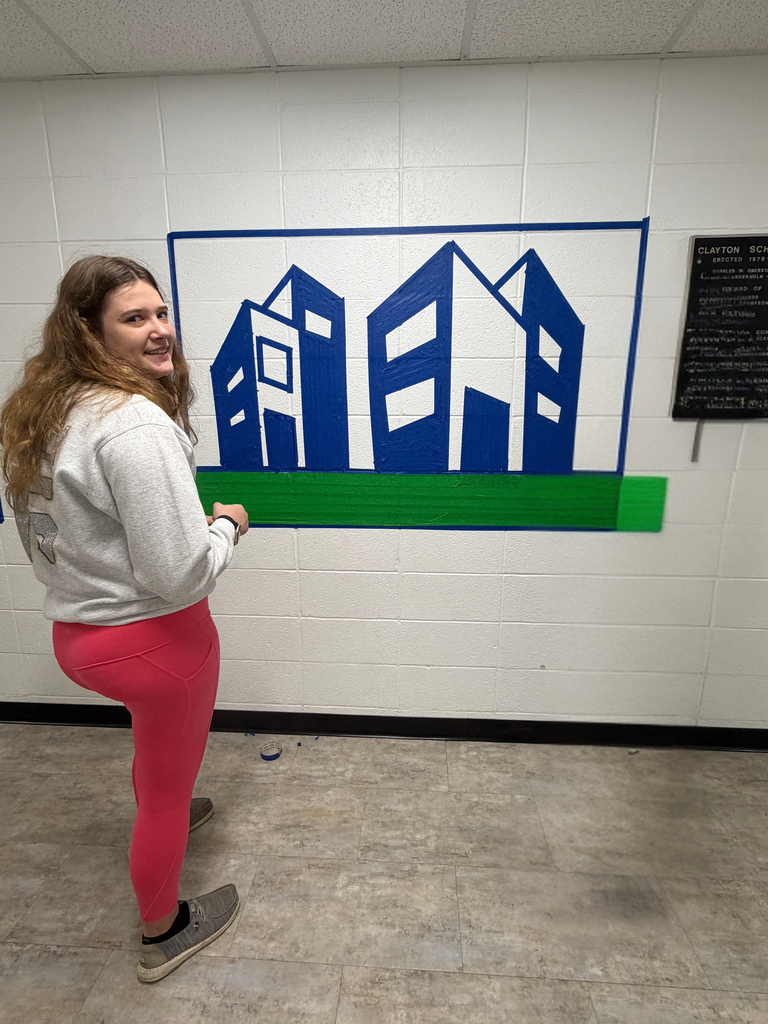 Students creating artwork in a hallway of a school