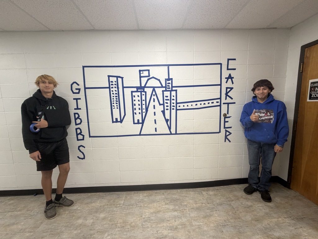 Students creating artwork in a hallway of a school 