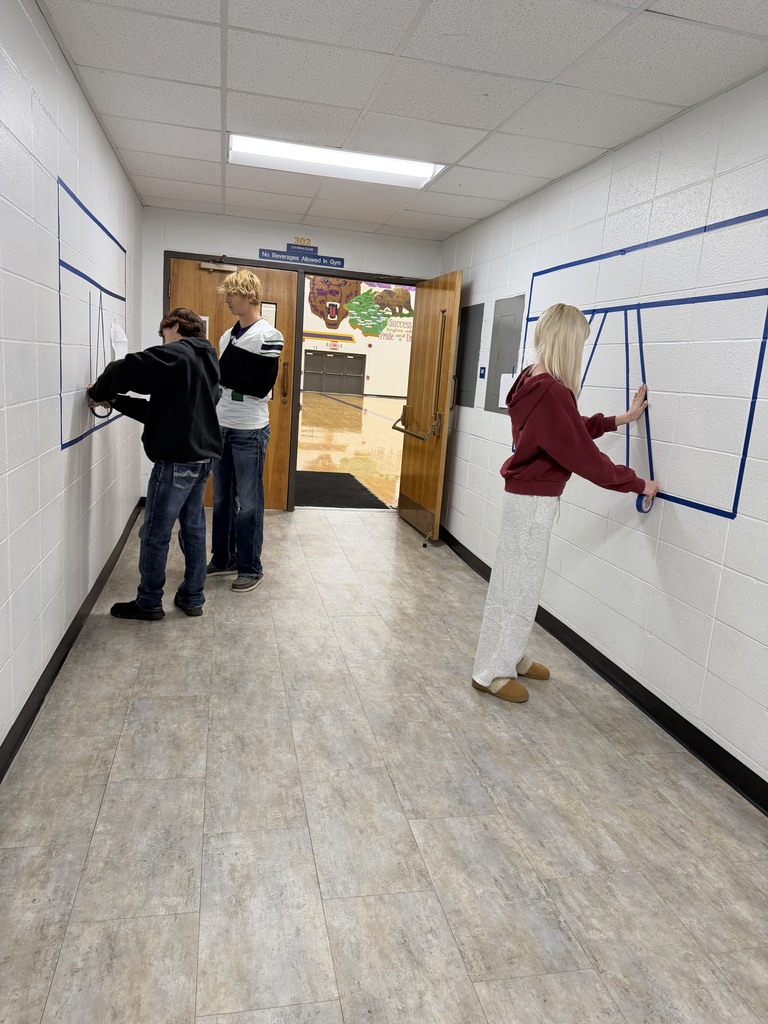 Students creating artwork in a hallway of a school 