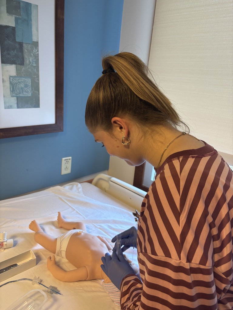 Student working on a pretend baby at a Career fair