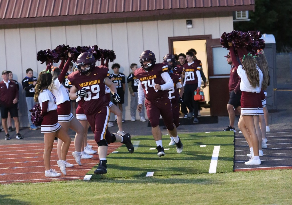 football players running out of the field house