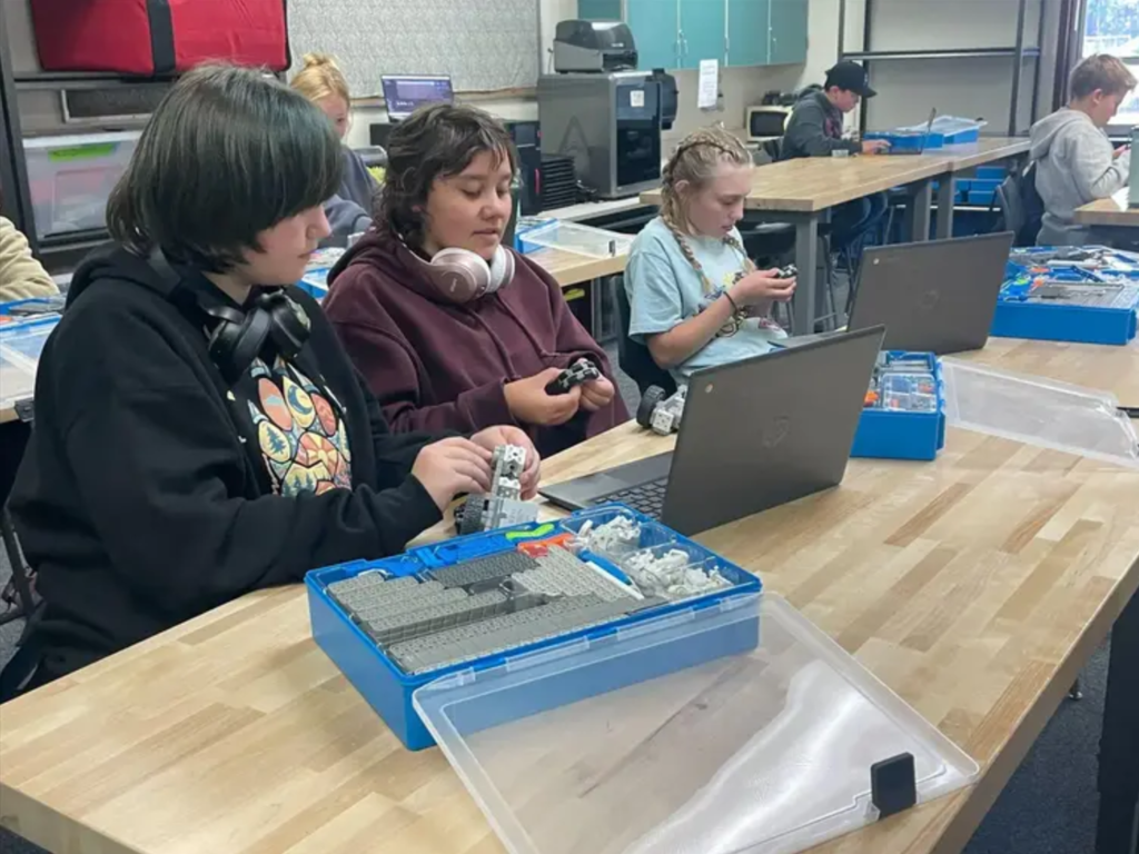 students sitting at a desk